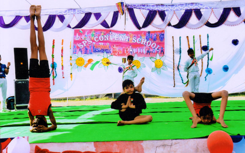 Students demonstrating yoga during a school programme