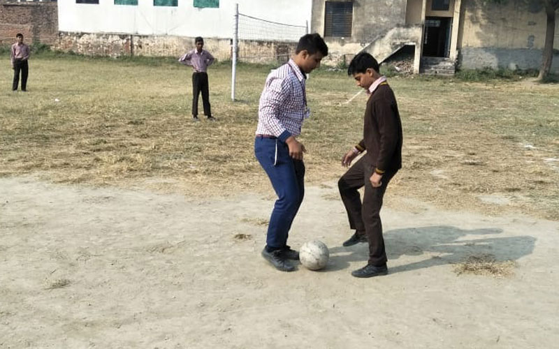 Students playing football on the school field