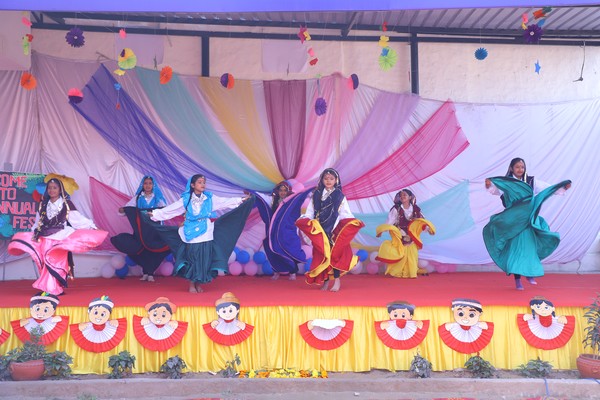 SPS students performing a colourful cultural dance on stage